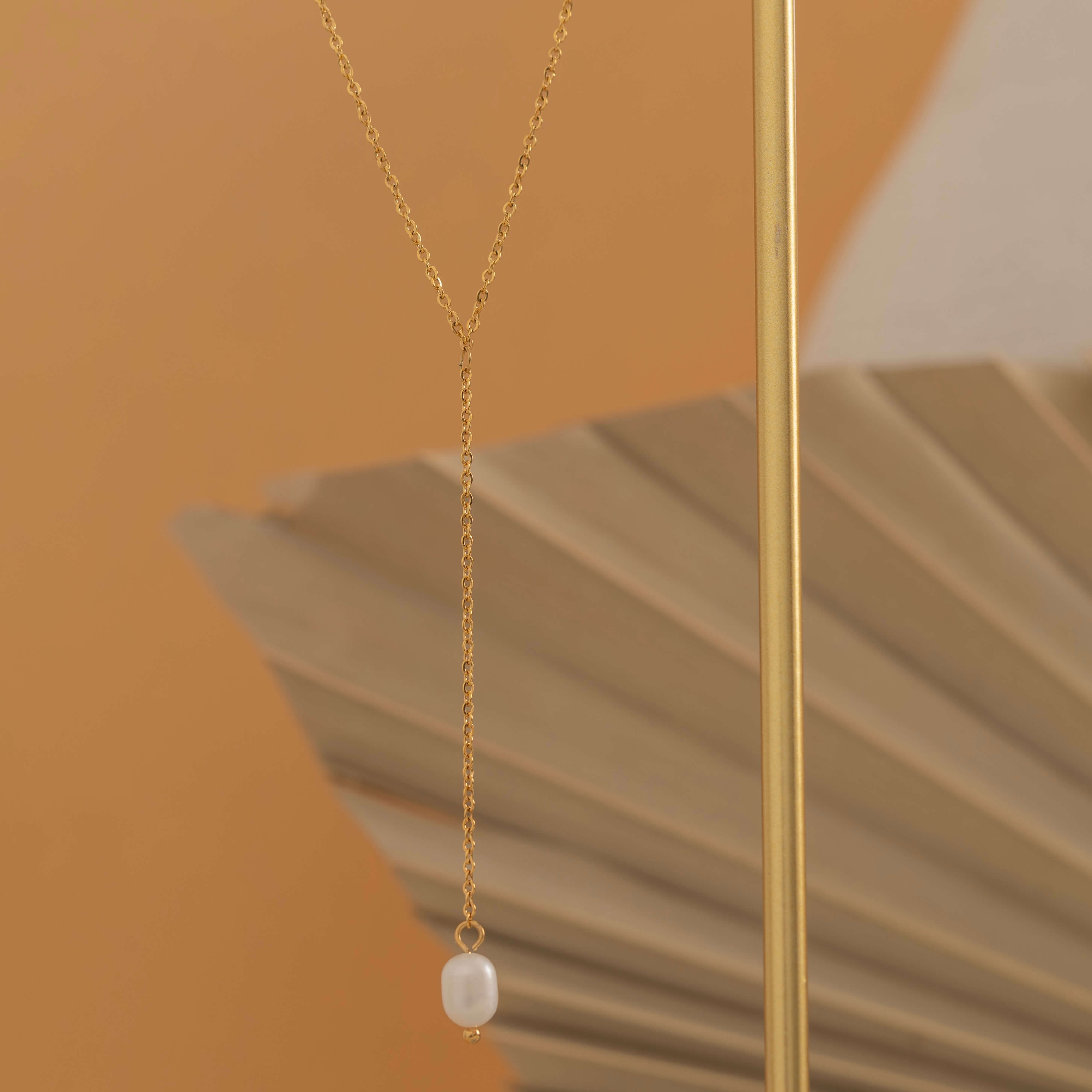 Gold lariat necklace with a freshwater pearl drop, shaped in a y necklace with  minimalist and elegant look.