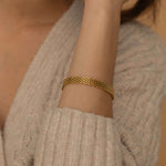 Elegant gold mesh bracelet with a unique design, tarnish-free and waterproof, perfect for adding sophistication to any outfit.