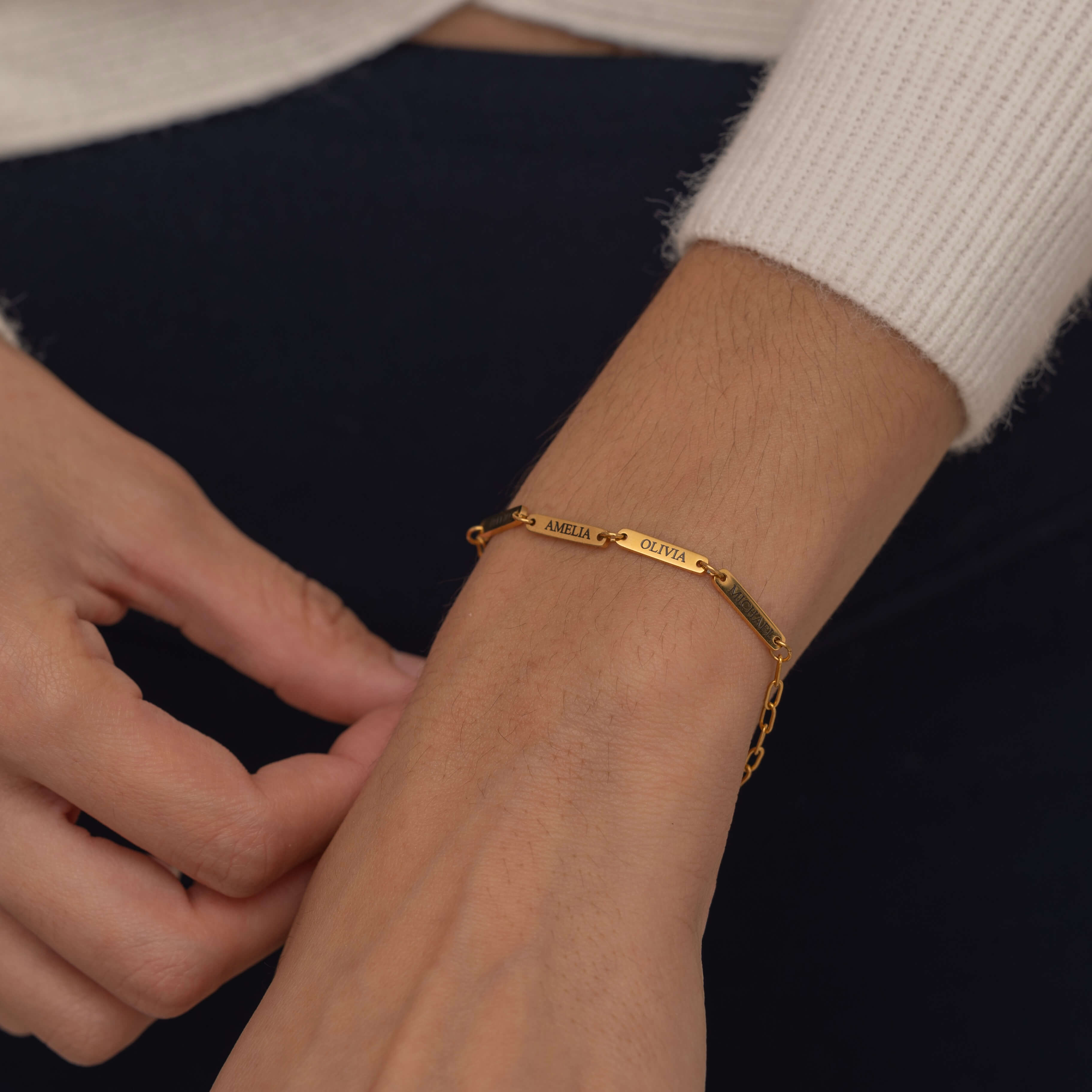 Gold multi-name bar bracelet with customizable engraved bars showcasing its elegant and personalized design.