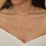 Gold lariat necklace with a freshwater pearl drop, shaped in a y necklace with  minimalist and elegant look.