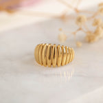 Elegant gold ribbed design ring from our exclusive jewelry collection, perfect for adding a touch of sophistication to any outfit.