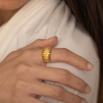 Elegant gold ribbed design ring from our exclusive jewelry collection, perfect for adding a touch of sophistication to any outfit.