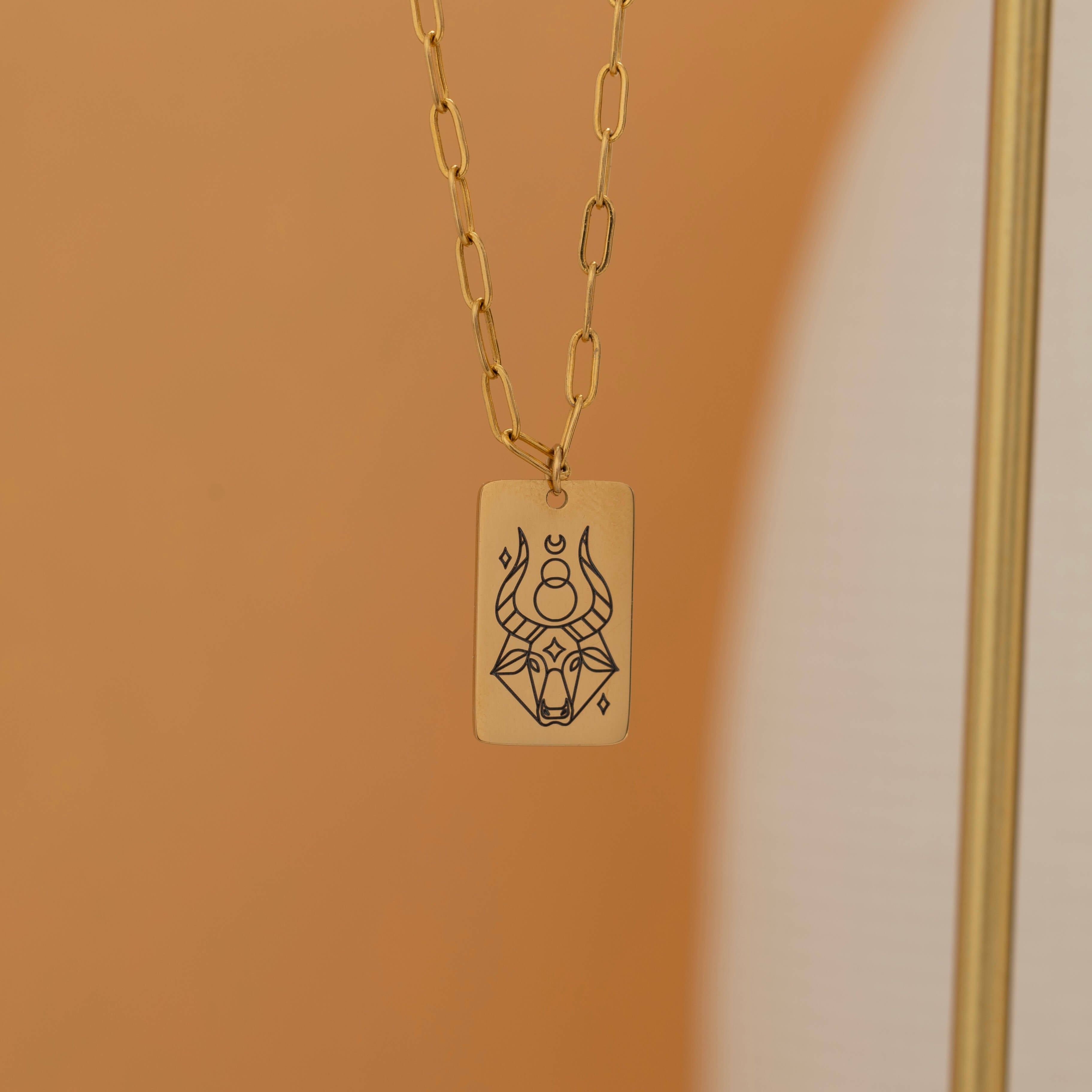 Gold zodiac pendant necklace with engraved zodiac symbol