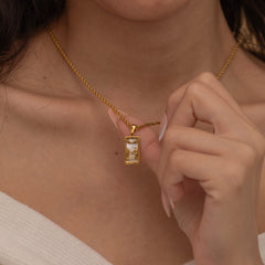 Gold the lovers tarot necklace with cubic zirconia accents and an mother of pearls back stone, symbolizing connection and unity