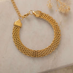 Close-up of a gold mesh bracelet showcasing its intricate design and durable, tarnish-free, and waterproof features.