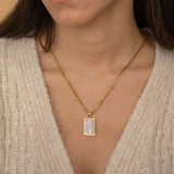 gold figaro chain with mother of pearl pendant perfect for everday wear 