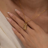 Gold and silver rectangular pendants with tiger engravings, featuring a sparkling cubic zirconia accent. They symbolize the strength tarot necklace. Available in both gold-plated and sterling silver chains.