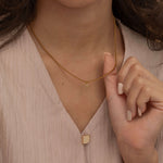 Gold initial pendant necklaces with crystal-studded alphabet charms on custom gold chains