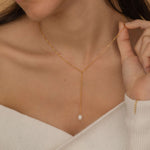 Gold lariat necklace with a freshwater pearl drop, shaped in a y necklace with  minimalist and elegant look.