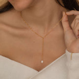 Gold lariat necklace with a freshwater pearl drop, shaped in a y necklace with  minimalist and elegant look.