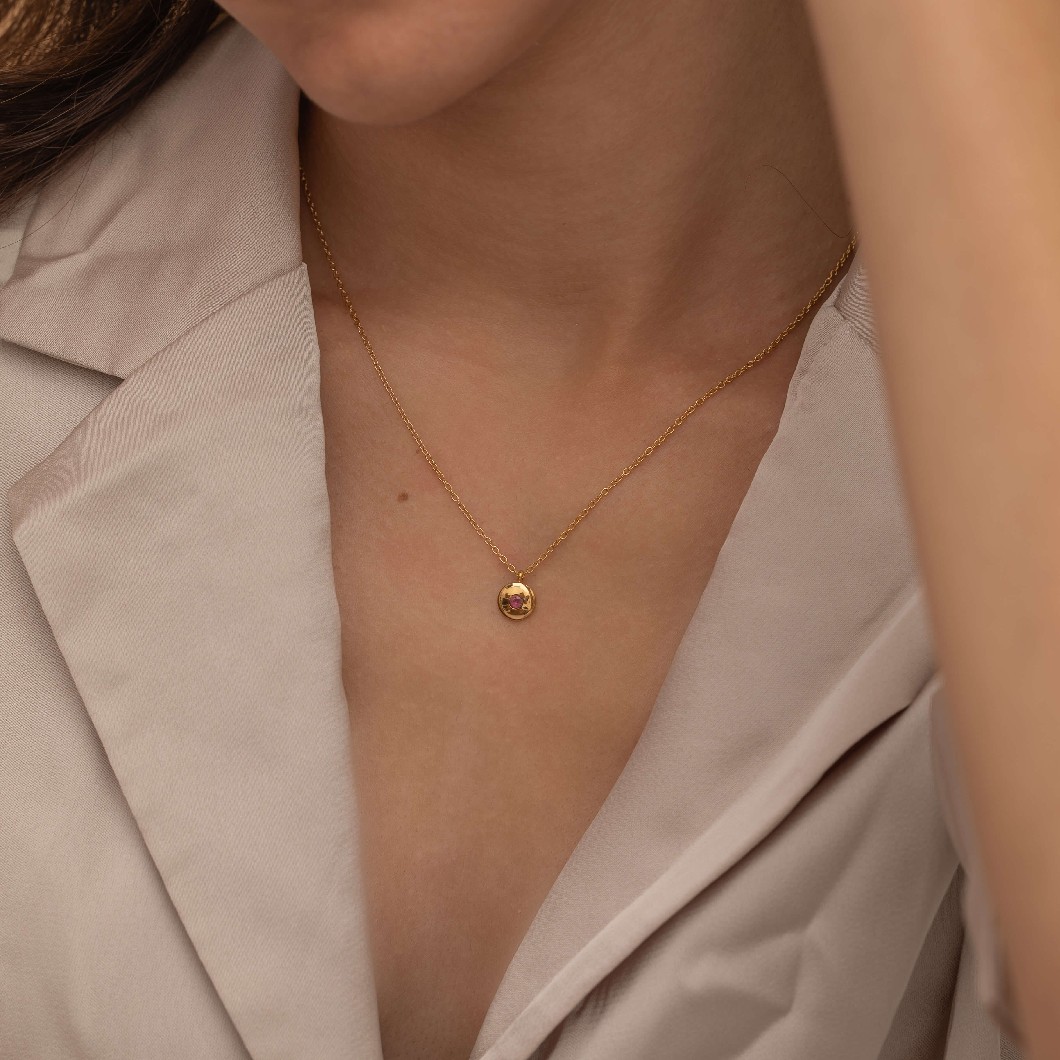 Round birthstone necklace with a polished coin pendant and center-set birthstone, offering personalized elegance and meaning for each birth month