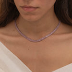 Elegant silver tennis necklace with a continuous row of sparkling, rectangular-cut stones. Perfectly aligned pink gemstones create a seamless shimmer, adding timeless sophistication to any look. Classic luxury jewelry piece ideal for formal occasions or adding everyday elegance.