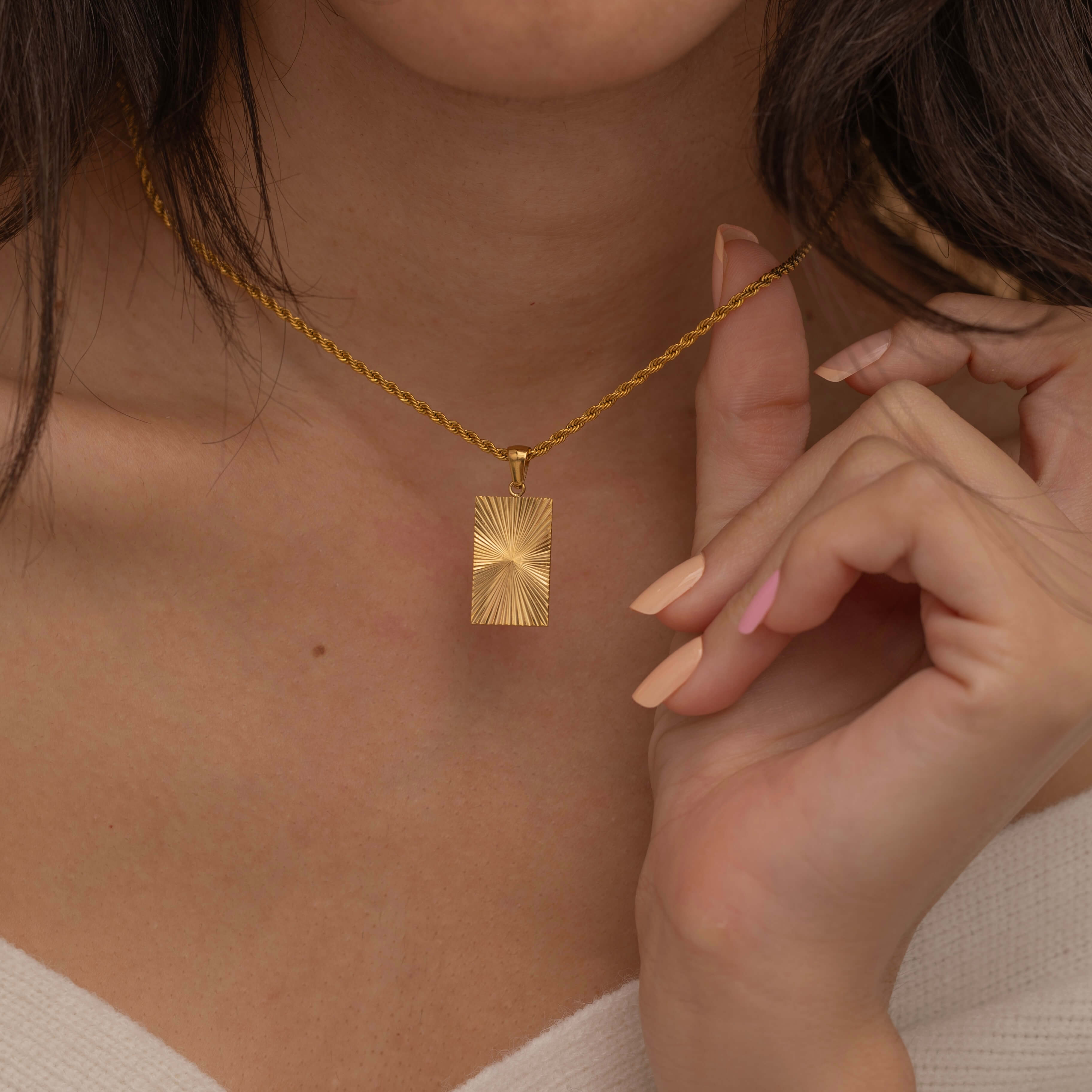 rectangle sunburst necklace with an etched sunburst design on a rectangle pendant, symbolizing warmth and vitality, perfect for adding a touch of boho elegance.