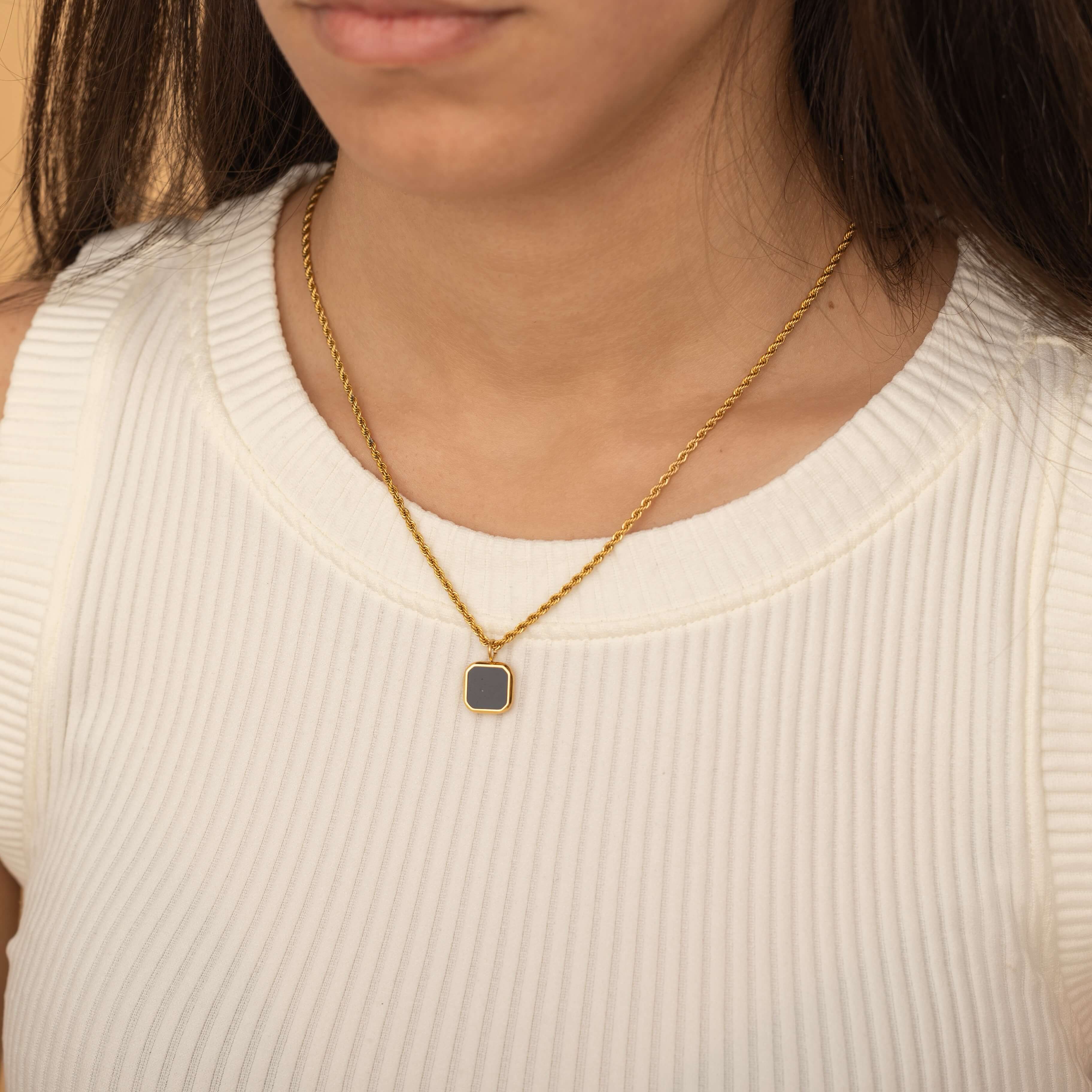 onyx square pendant in gold with a rope style chain necklace