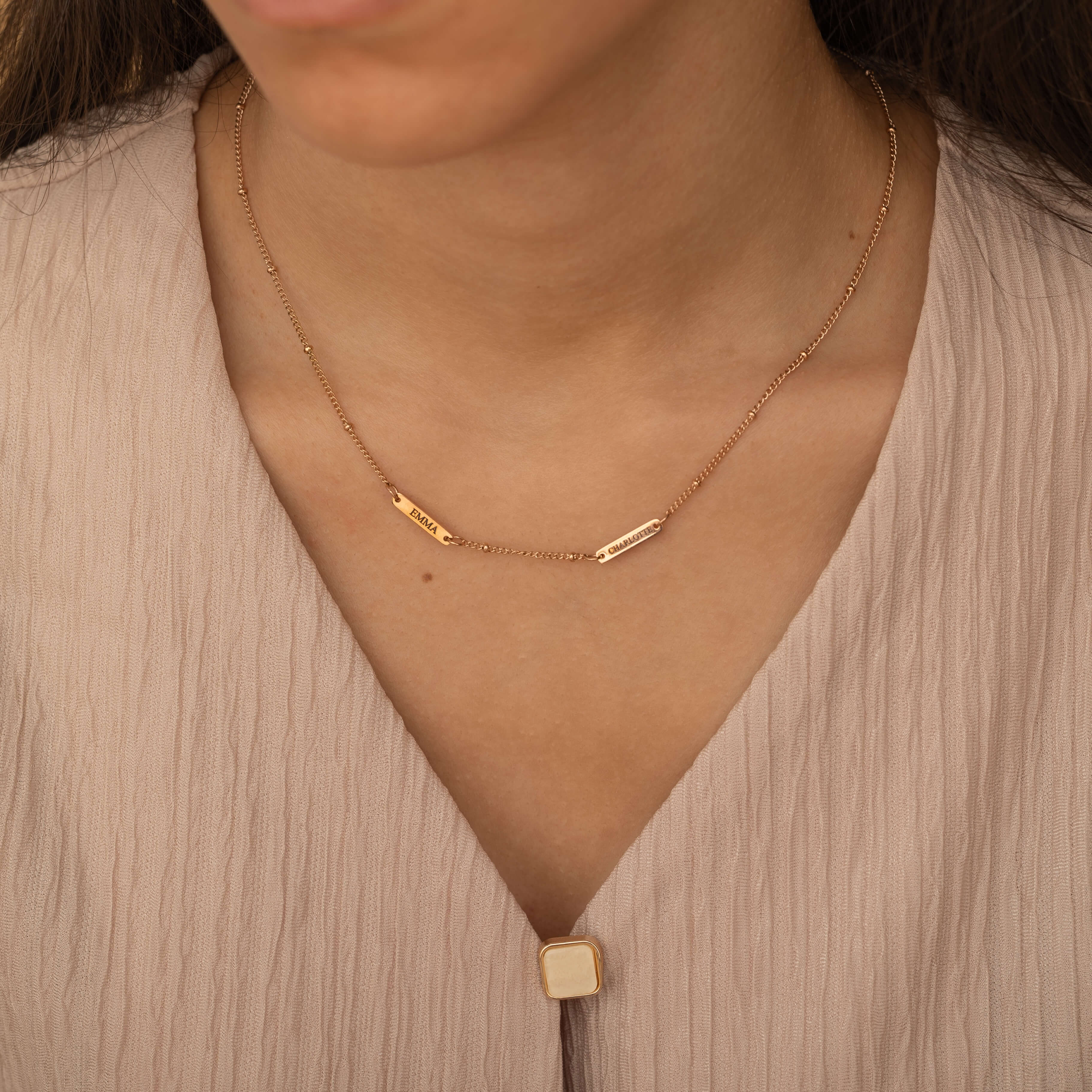 Rose Gold necklace with multiple engraved name bar charms, personalized family name jewelry