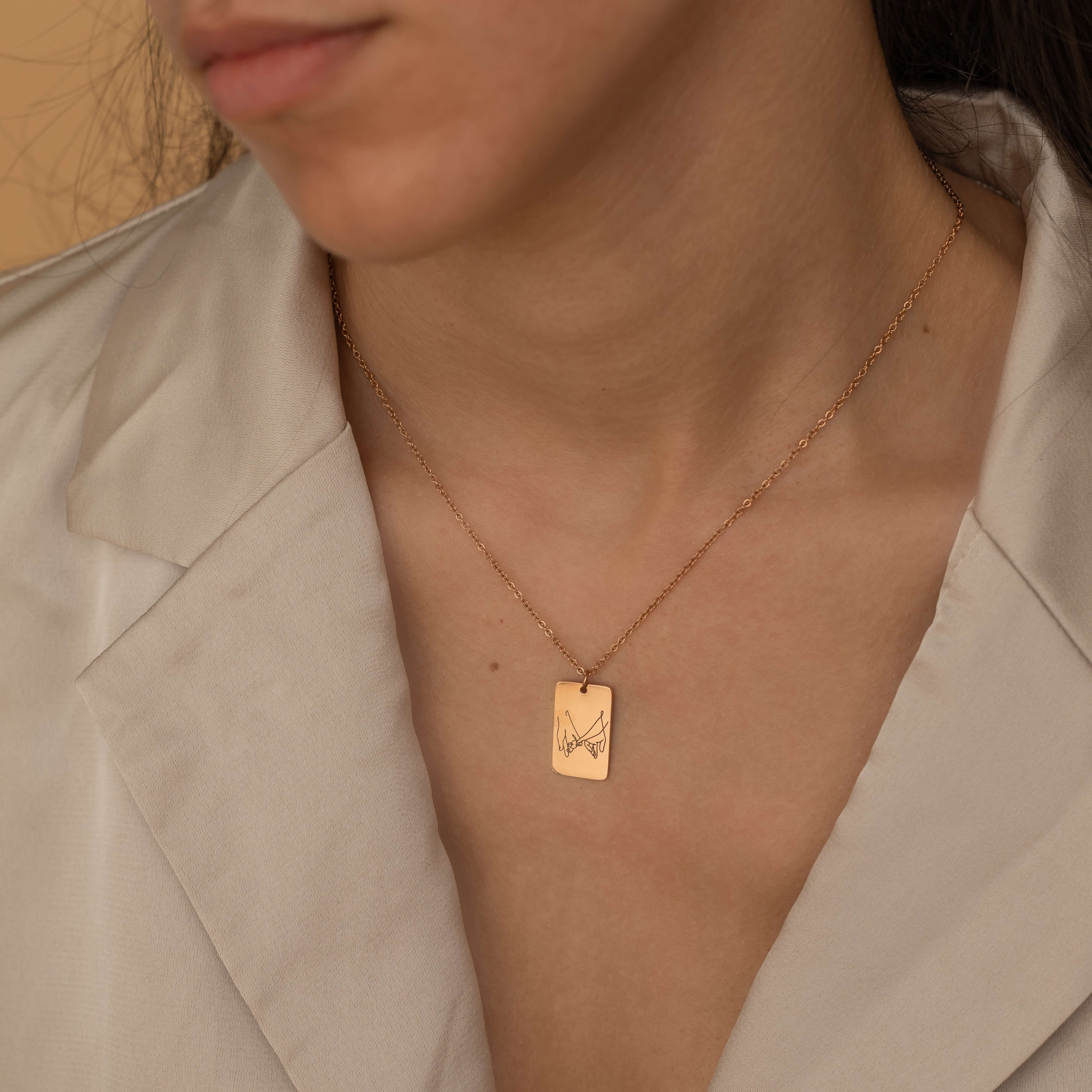 custom hand sign symbol necklaces in gold, silver, and rose gold with engraved rectangular pendants featuring various hand sign designs.