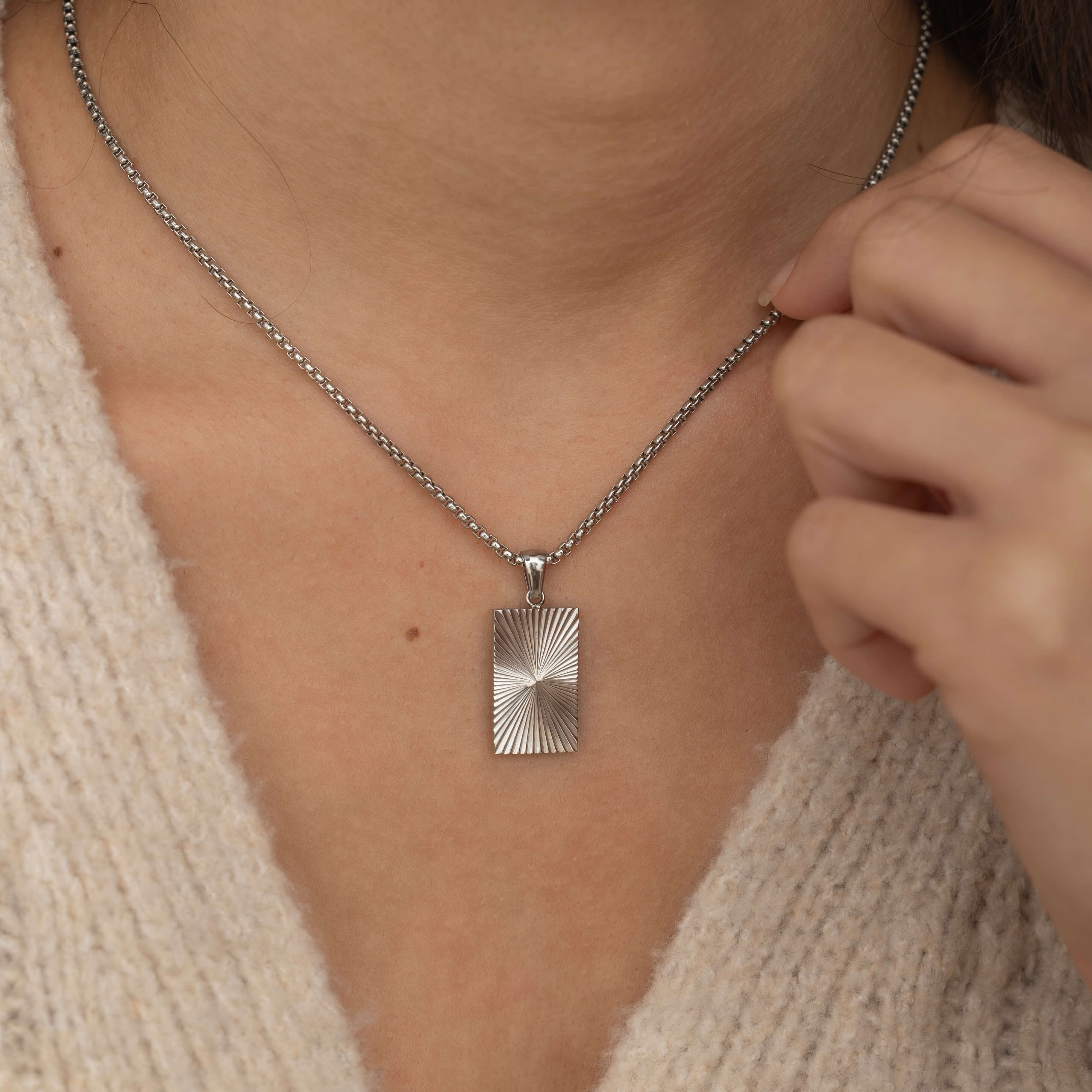 rectangle sunburst necklace with an etched sunburst design on a rectangle pendant, symbolizing warmth and vitality, perfect for adding a touch of boho elegance.