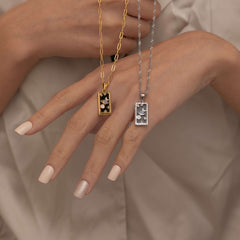 Silver and Gold the world tarot necklace with cubic zirconia accents and an black onyx back stone, symbolizing completion, unity, and the cyclical nature of life