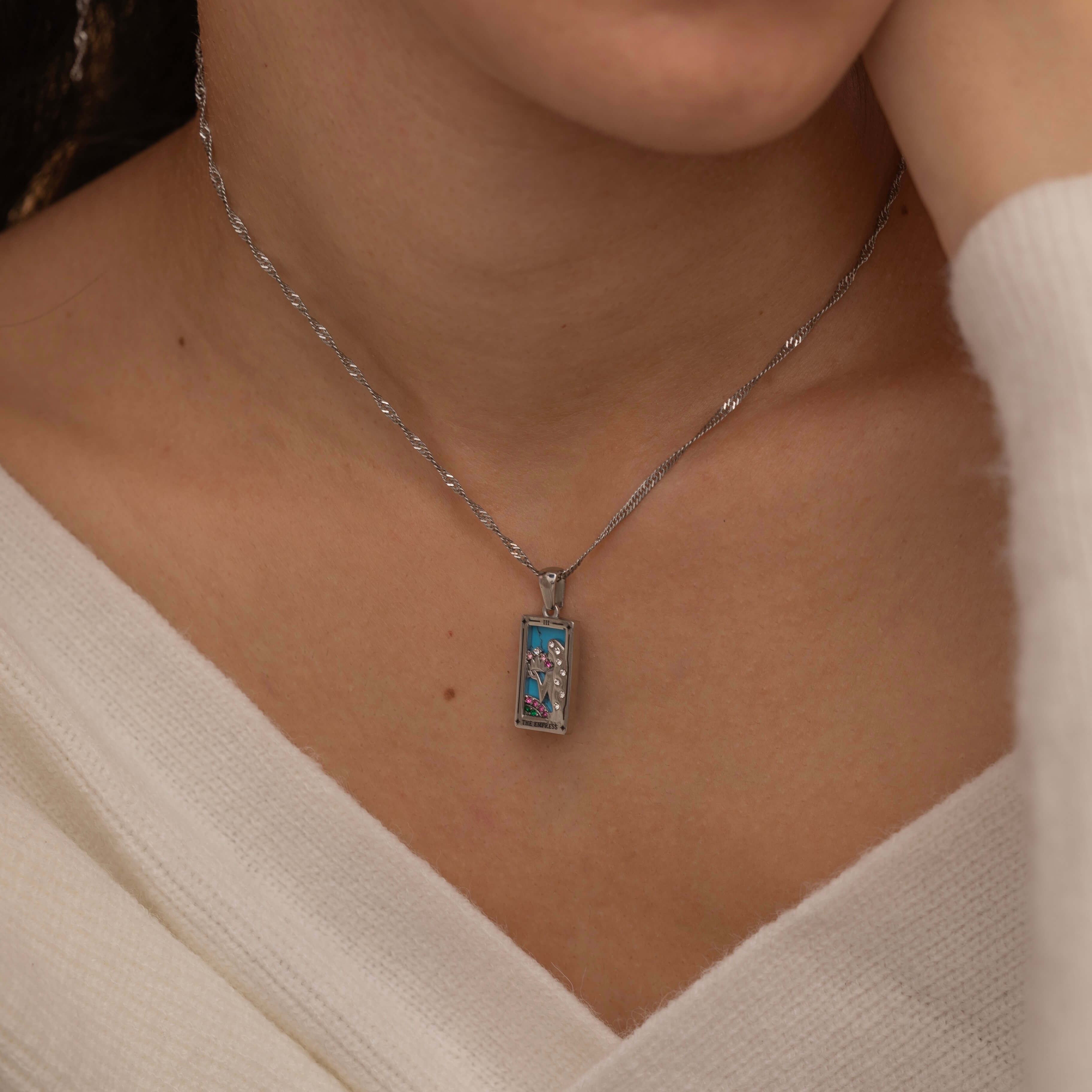  silver empress tarot necklace with cubic zirconia accents and an turquoise back stone, symbolizing abundance, beauty, and feminine power. 