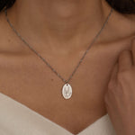 Silver hand gesture necklace. Up close of rocker hand sign engraving 