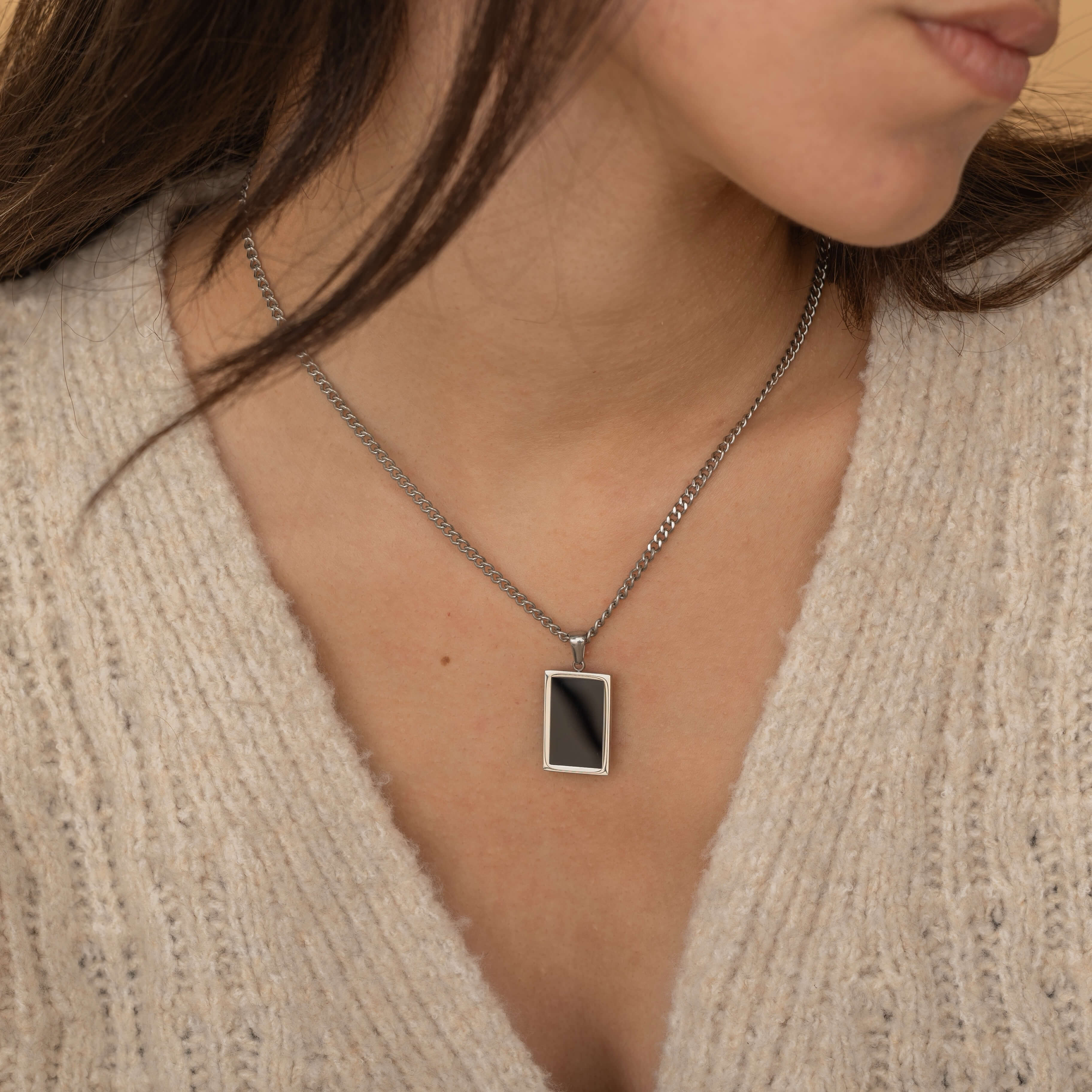 Rectangular onyx pendant in silver chain necklace. 