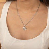 Circle sunburst necklace with an etched sunburst design on a round pendant, symbolizing warmth and vitality, perfect for adding a touch of boho elegance.