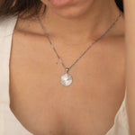 Circle sunburst necklace with an etched sunburst design on a round pendant, symbolizing warmth and vitality, perfect for adding a touch of boho elegance.
