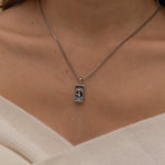 Silver Temperance tarot necklace with cubic zirconia accents and an onyx back stone, symbolizing balance and harmony.