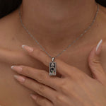 Silver magician tarot necklace with cubic zirconia accents and an onyx back stone, symbolizing the balance of elemental force.