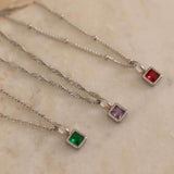 Square birthstone charms in gold and silver frames on a necklace, with multiple colorful birthstone charms representing different birth months