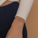 Single initial bracelet in silver, gold, or rose gold with a personalized charm on a delicate chain for a classic, customizable accessory.