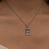 
Silver the wheel tarot necklace with cubic zirconia accents and an black onyx  back stone, symbolizing change, destiny, and the cycles of life. 
