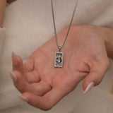 Silver Temperance tarot necklace with cubic zirconia accents and an onyx back stone, symbolizing balance and harmony.