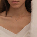 Dainty sterling silver and 14k gold plated necklace featuring four square turquoise birthstone stones, one centered teardrop-shaped turquoise stone, and four white cubic zirconia accents between the turquoise stones. Perfect for mother’s day and prom. 