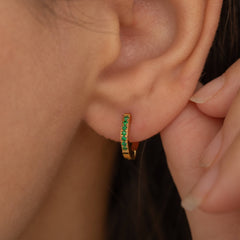 gold emerald huggie hoop earrings