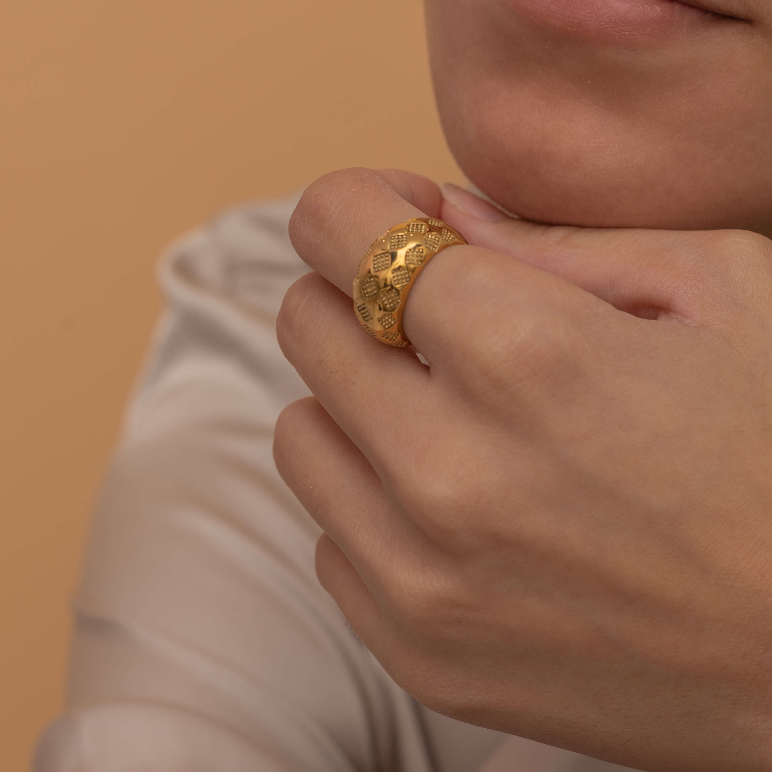 Gold checkered ring with textured design, stylish and modern statement jewelry piece