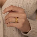 Sophisticated gold ring with a detailed woven texture